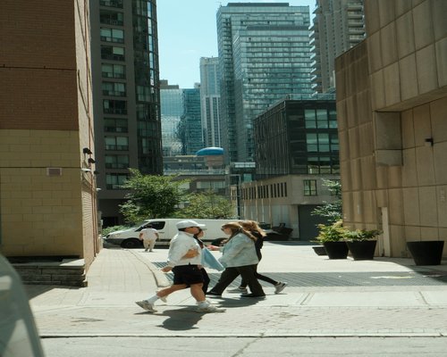 Colleagues walking together during a lunch break in a city district
